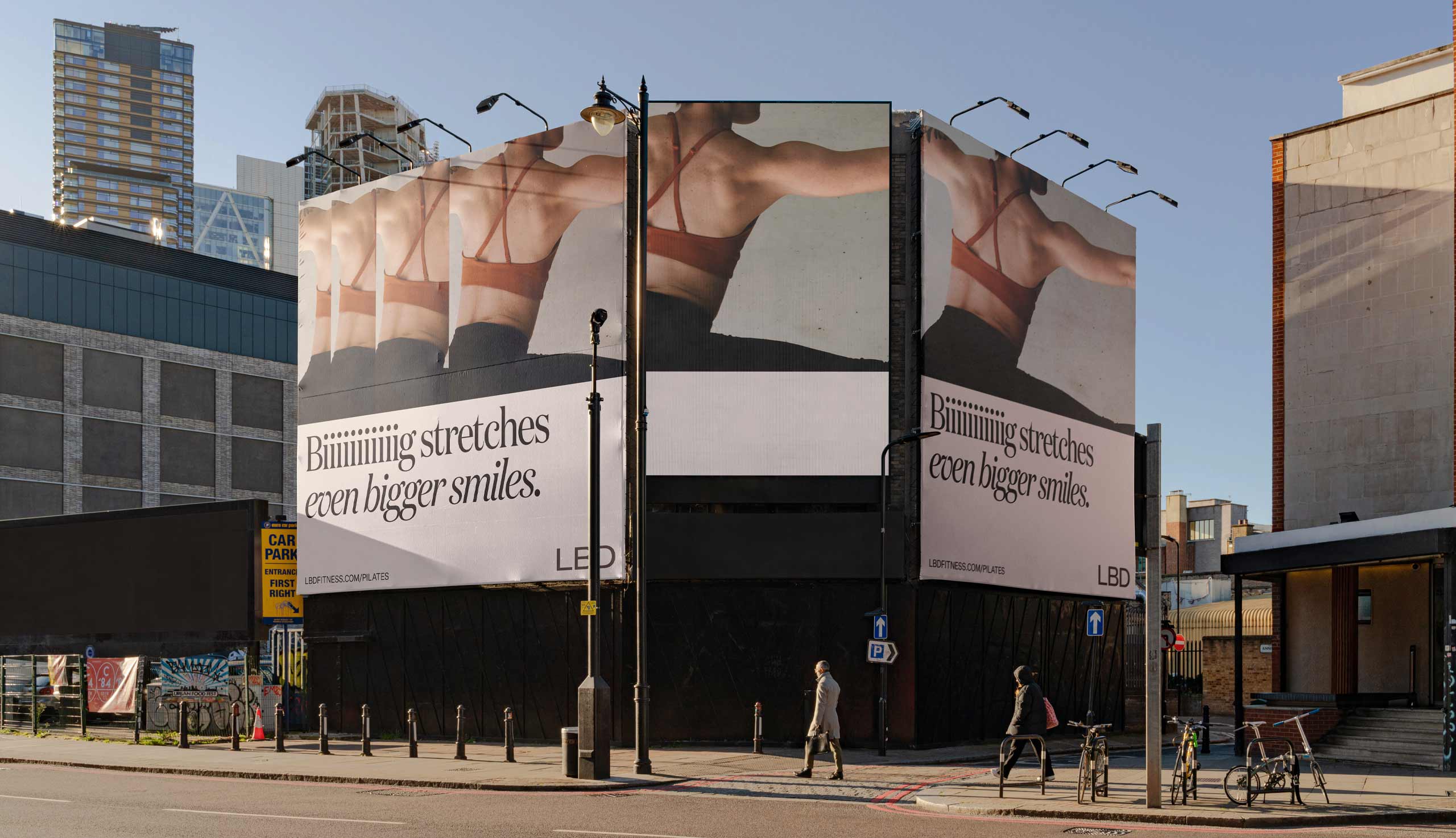 A person doing pilates stretches across 3 billboards depicting a big stretch, alongside text that says "Big stretches, even bigger smiles" For an LBD pilates advert designed by Kyle Wilkinson Studio