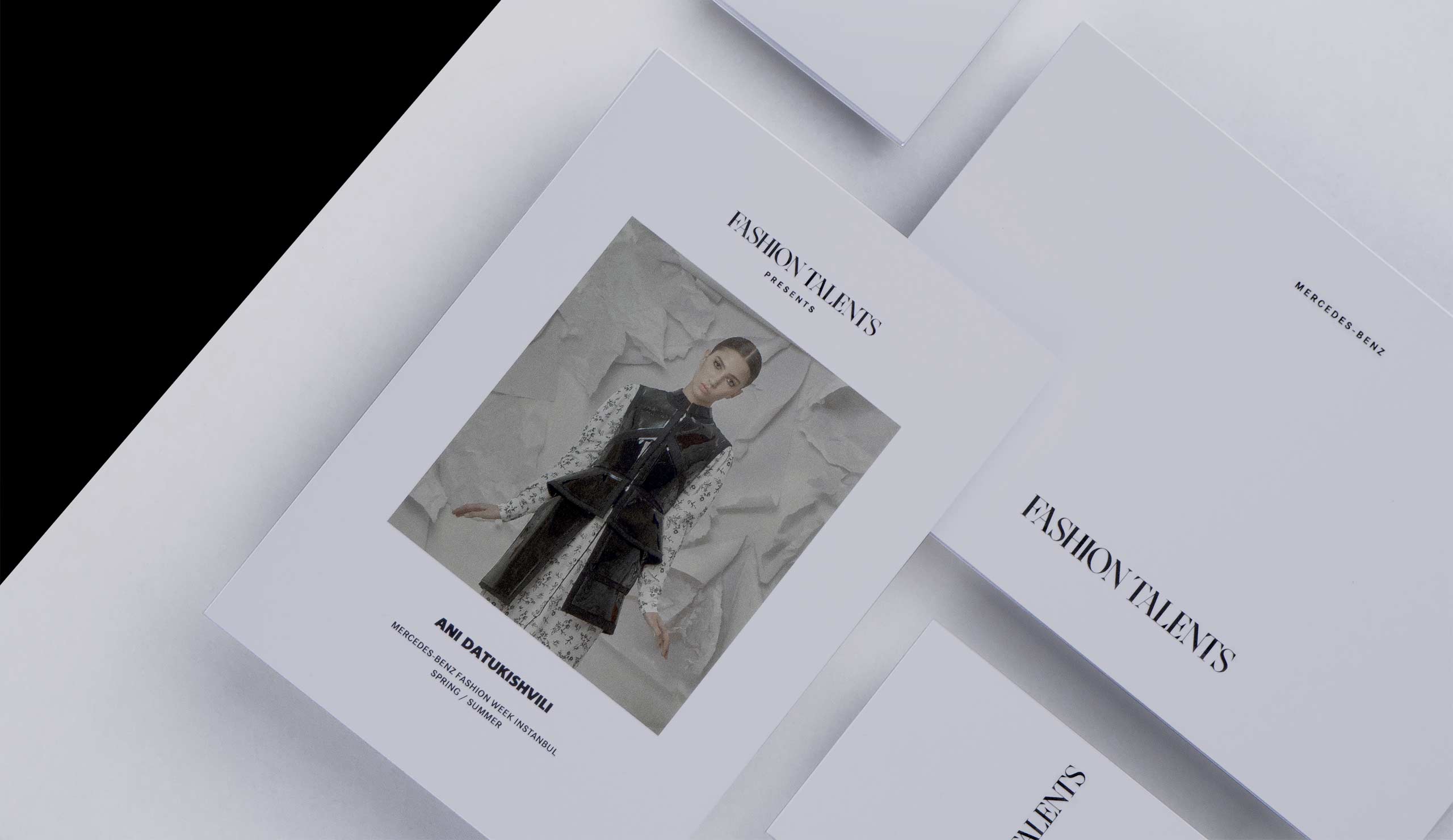 White branding on a black background with a Mercedes Benz Fashion Talents logo designed by Kyle Wilkinson Studio